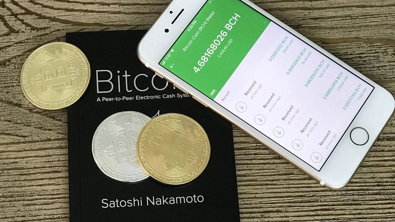 Buying Dubai property with cryptocurrency: gold and silver coins beside a phone showing a crypto wallet