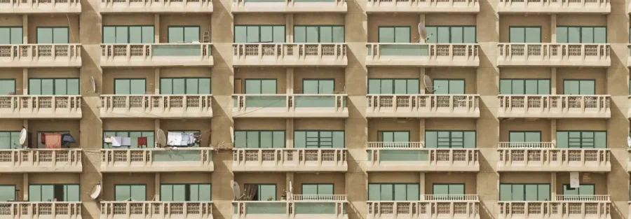 Apartment block facade beside Dubai Creek, a reminder of the many licensed entities to close a company in the UAE properly