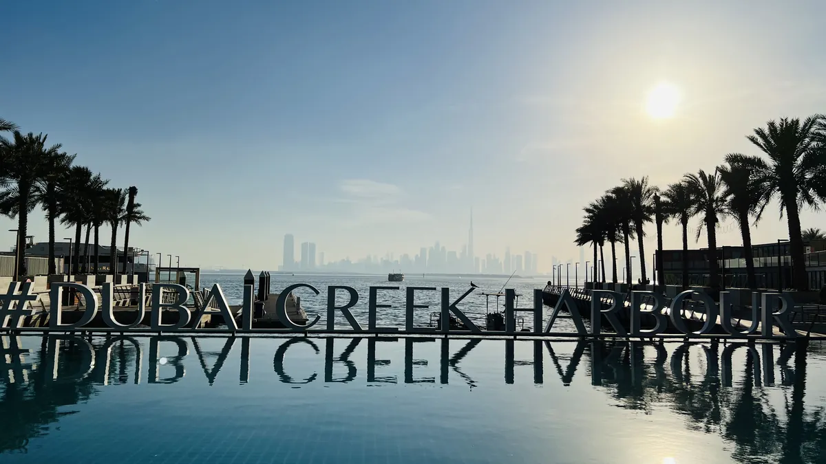 Dubai Creek Harbour sign above a pool, a new community where snagging in Dubai happens at handover