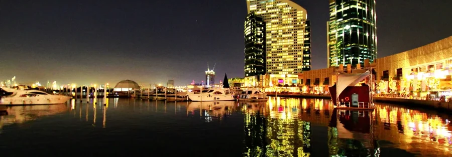 Festival City marina at night, a Dubai district where a Dubai real estate agent commission is agreed on every resale
