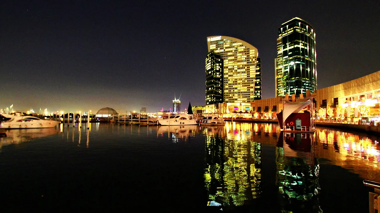 Festival City marina at night, a Dubai district where a Dubai real estate agent commission is agreed on every resale