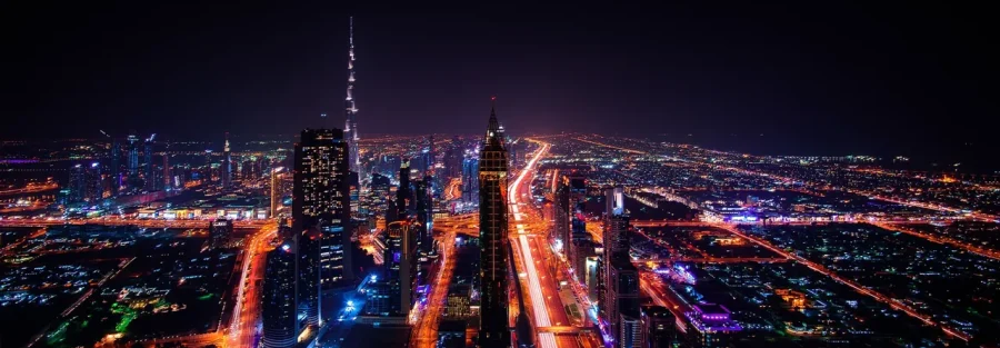 Dubai REITs and property investment: aerial night view of Sheikh Zayed Road and the Dubai skyline