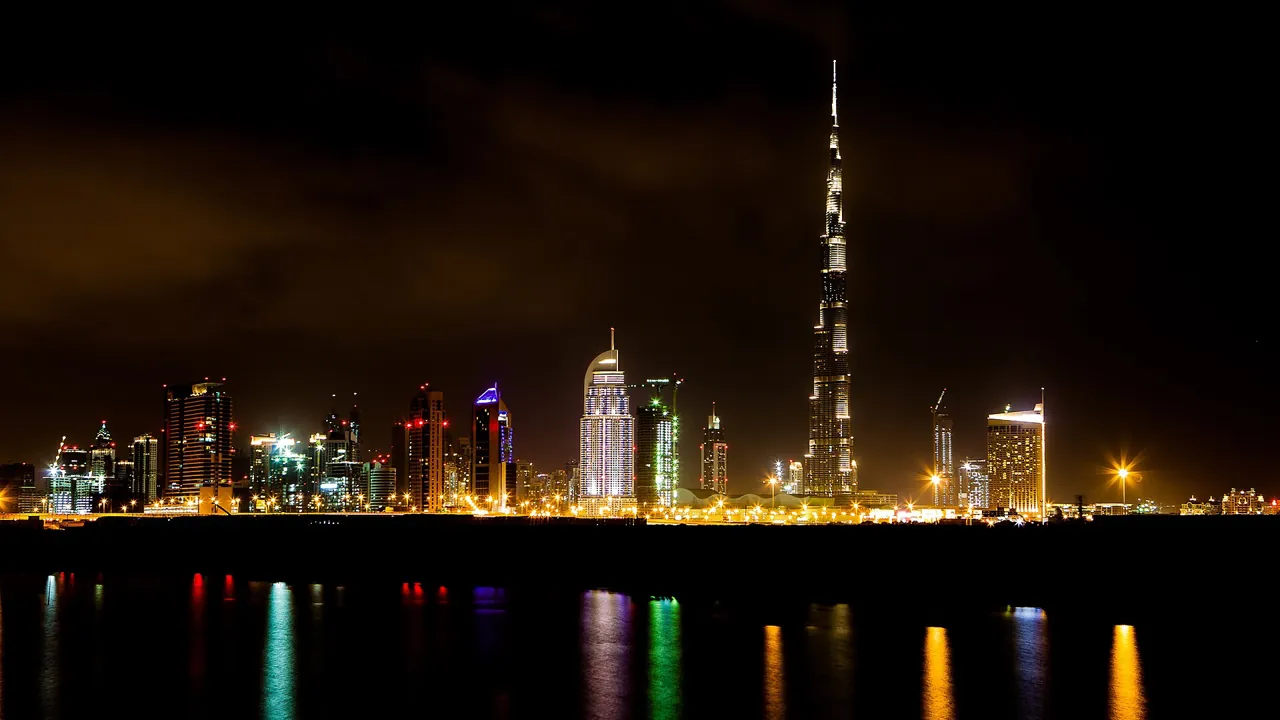 Dubai REITs vs buying property: Downtown Dubai skyline reflected on the water at night