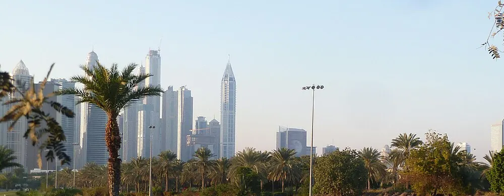 Dubai Marina residential towers rising above the Emirates Hills golf course