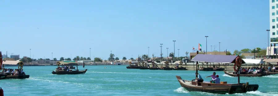 Re-export from the UAE: traditional boats crossing Dubai Creek, the historic trading waterway of Dubai