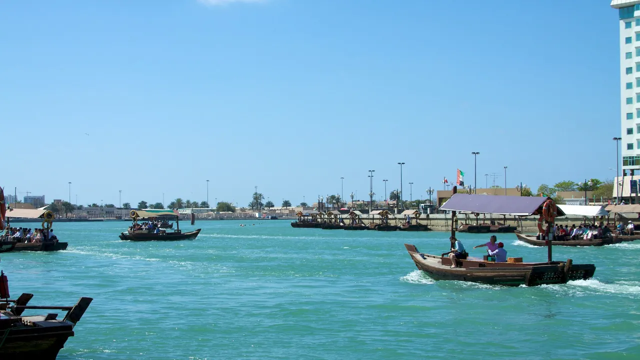 Re-export from the UAE: traditional boats crossing Dubai Creek, the historic trading waterway of Dubai