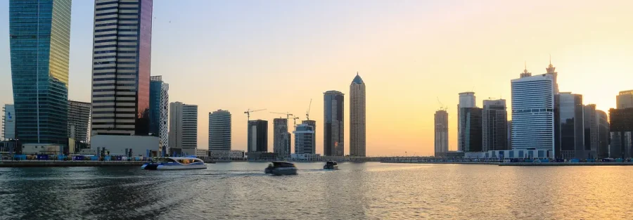 Business Bay towers over the Dubai Water Canal at sunset, a typical setting when owners sell a UAE company