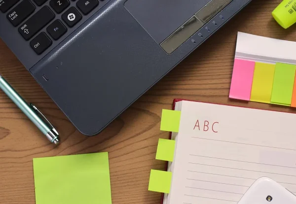 Laptop, pen and notebook on a desk for planning UAE dividends foreign shareholders