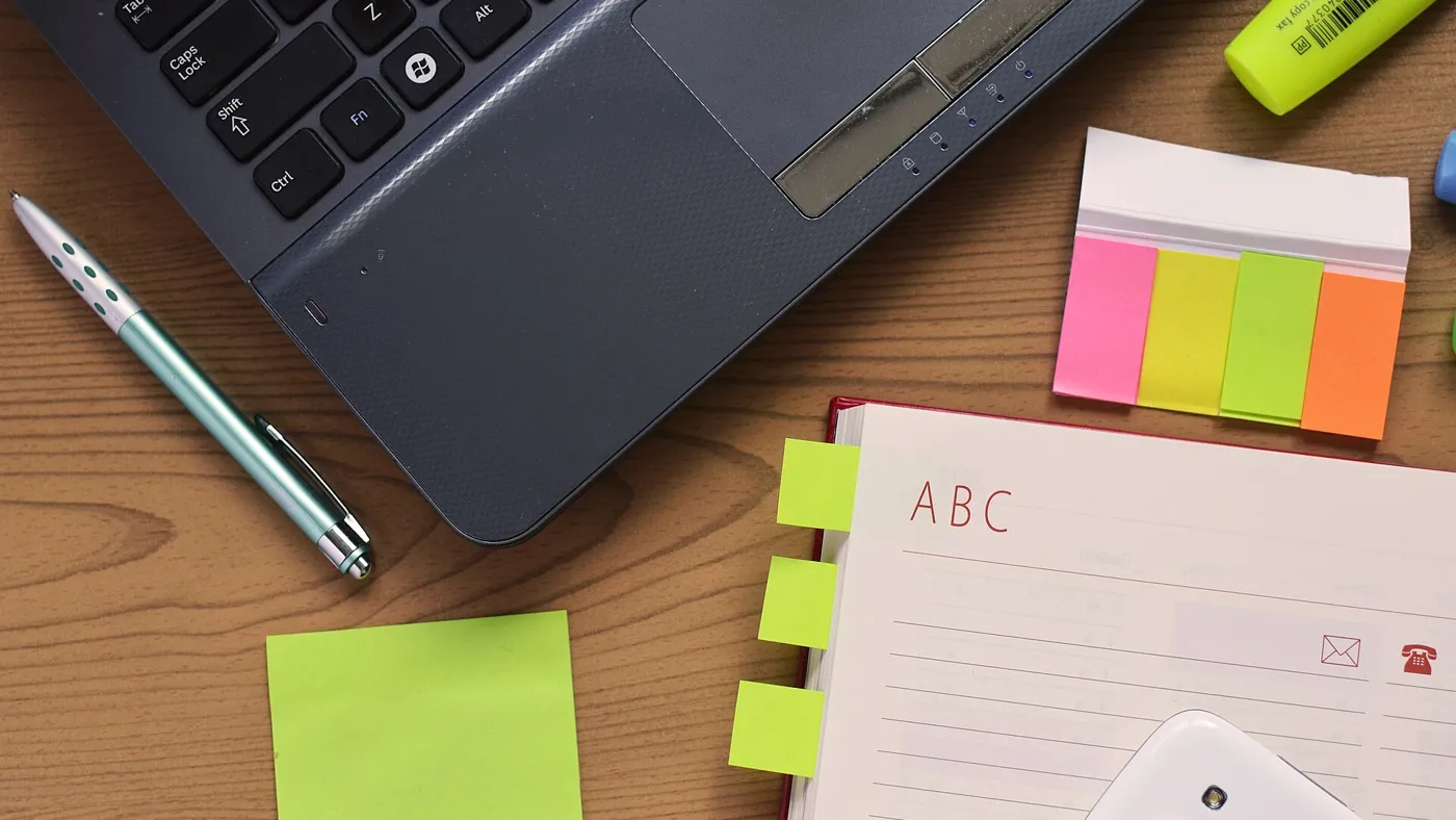 Laptop, pen and notebook on a desk for planning UAE dividends foreign shareholders