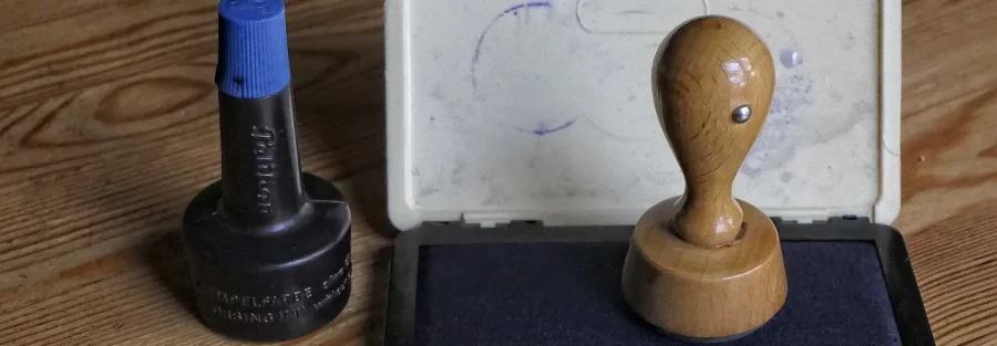 A stamp and ink pad, a simple picture of UAE trademark registration as an official mark