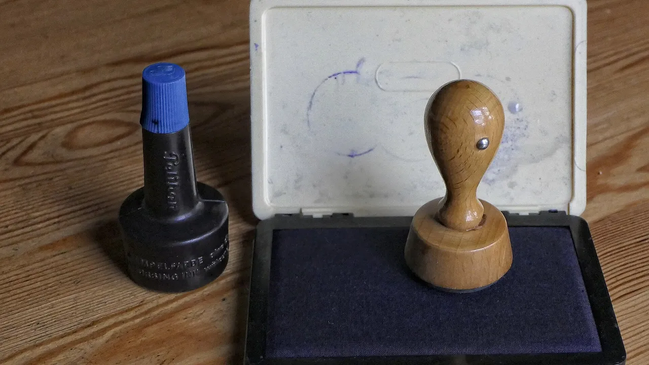 A stamp and ink pad, a simple picture of UAE trademark registration as an official mark